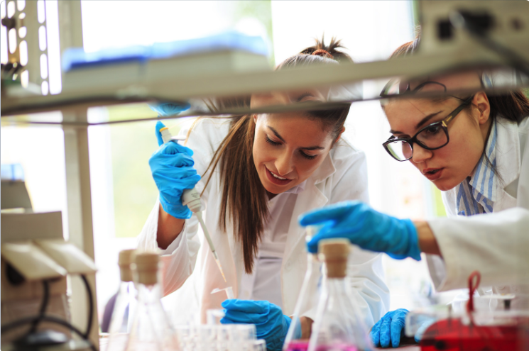 two lab technicians working with beakers